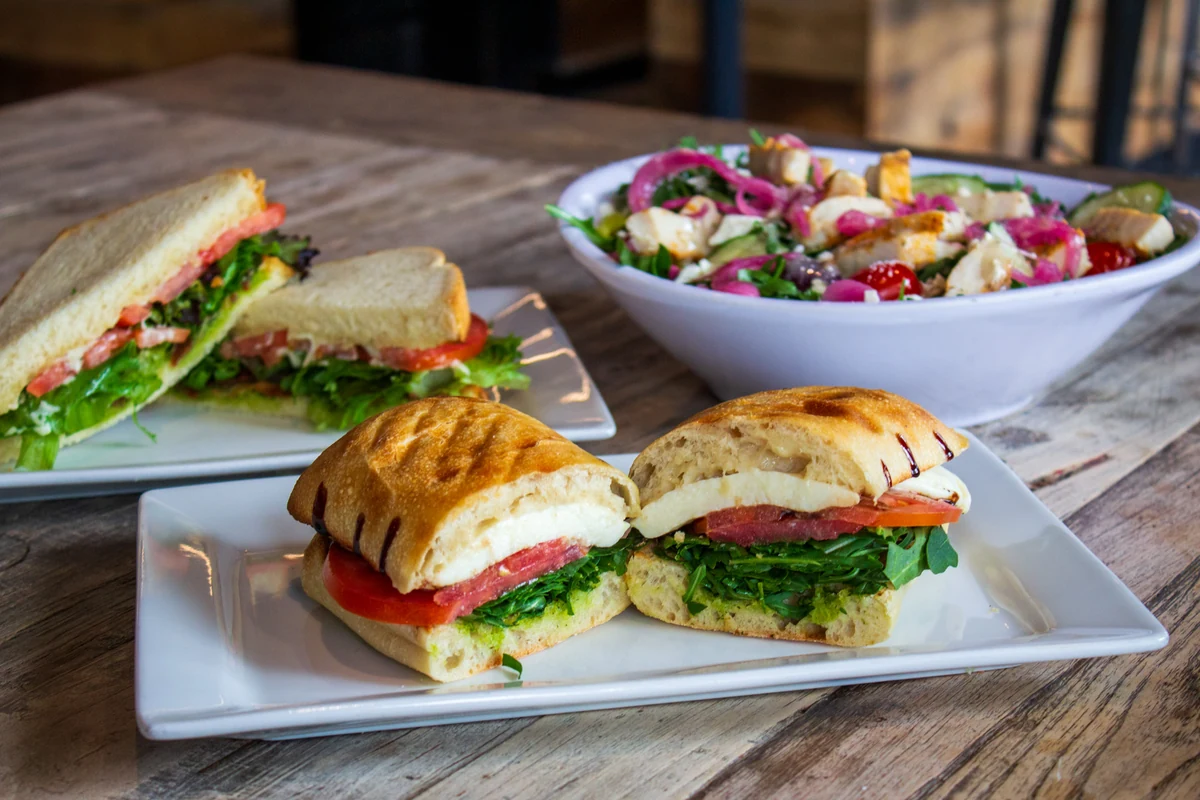Fuel America sandwiches and a colorful salad on a café table.
