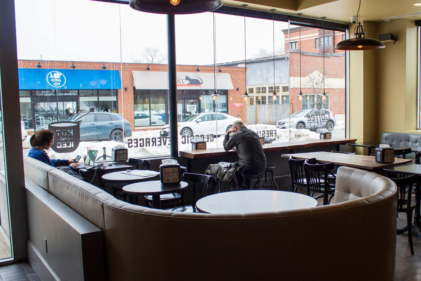 Brighton café seating beside the large Chestnut Hill Avenue windows.